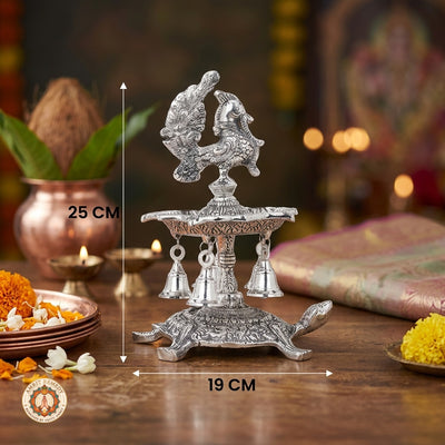Silver Plated Peacock Diya with Tortoise Pedestal & Bells (25 cm)